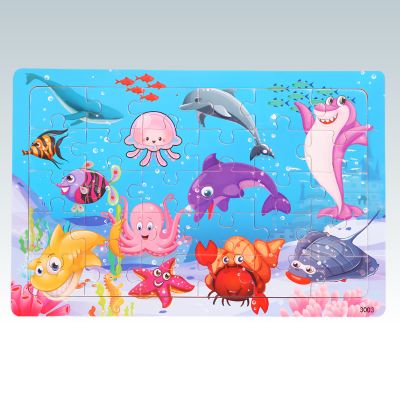 puzzle en bois enfant avec dauphins, requin, poulpe, poissons et crabe sous l’eau 