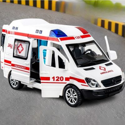 ambulance jouet blanche et rouge avec portes ouvertes sur une route miniature